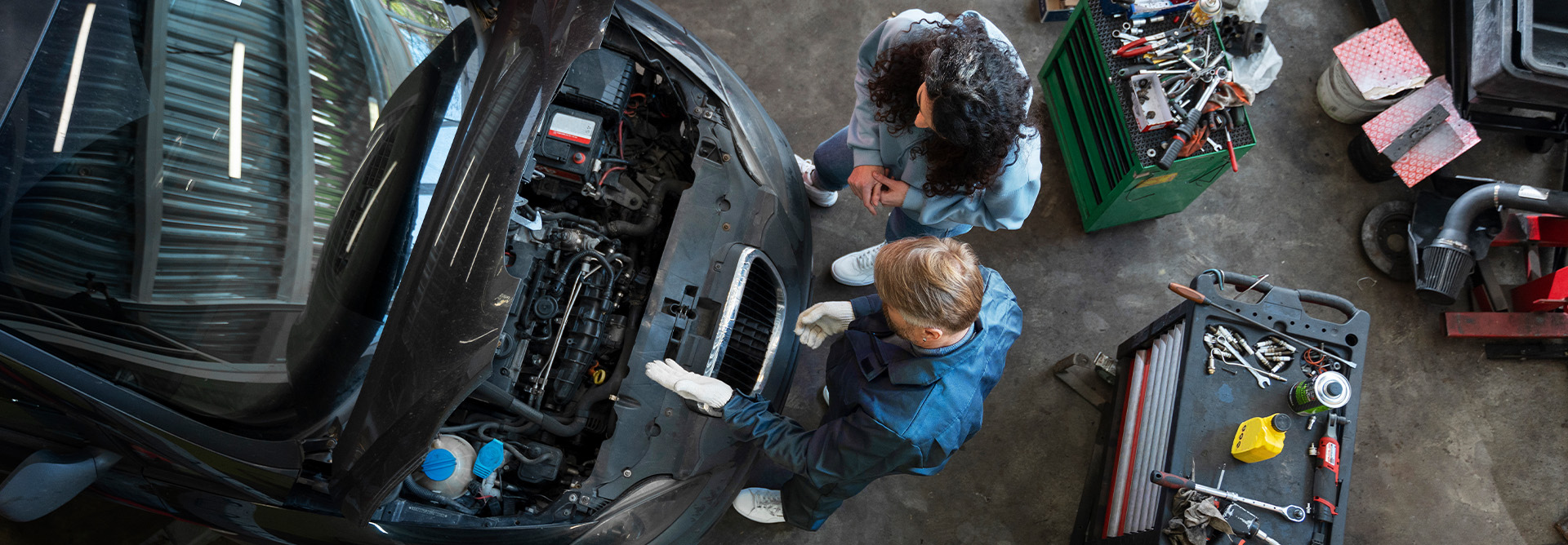muscular-car-service-worker-repairing-vehicle